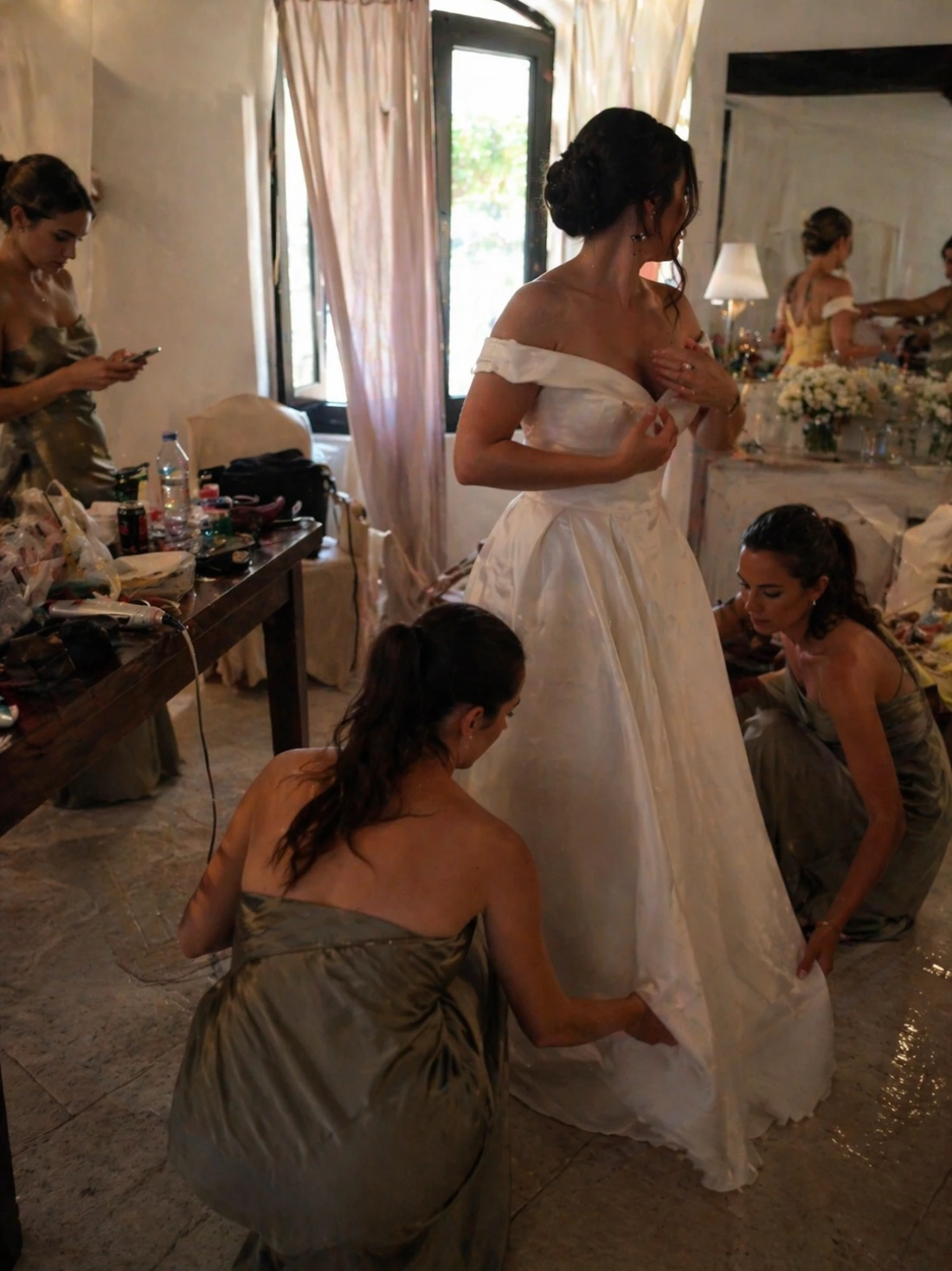Bride getting ready with bridesmaids before the wedding