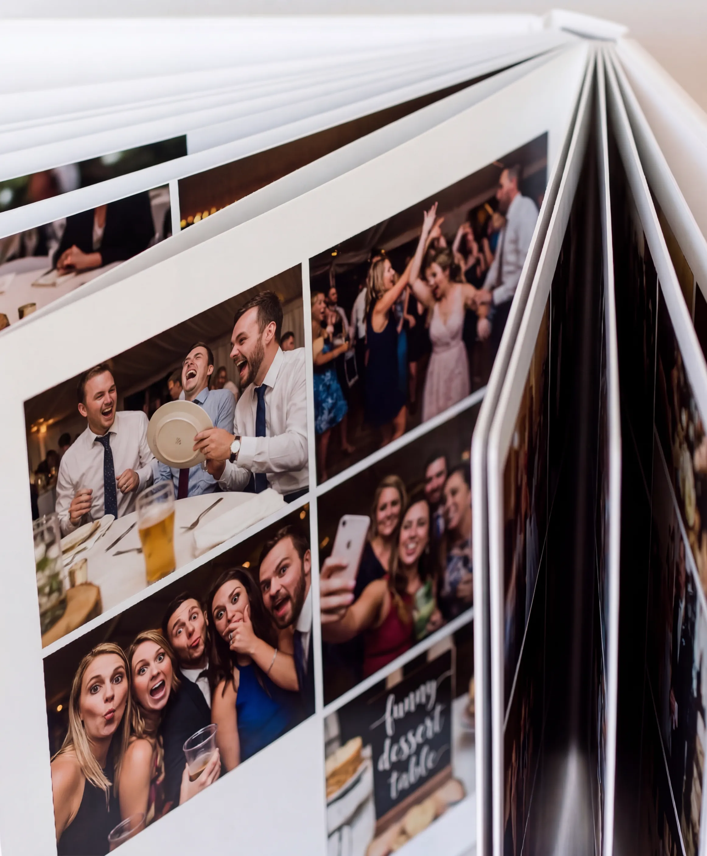 Open photobook spread of guest photos from the dance floor and the dessert table